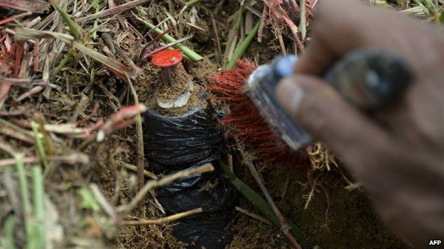 A Colombian soldier practices with a fake mine as part of his training before searching for real land mines as part of the humanitarian demining, in Campo Alegre, Cocorna municipality, East of Antioquia department, Colombia on April 16, 2015