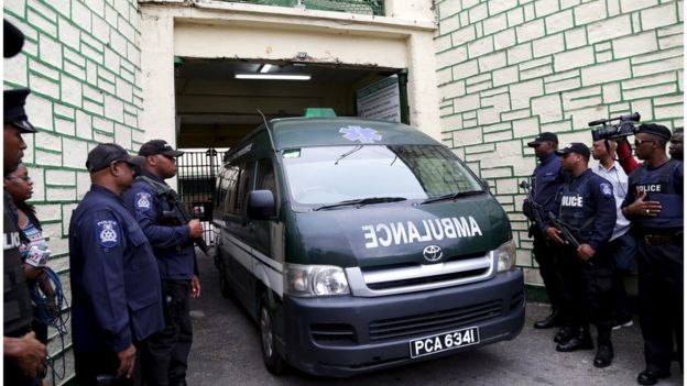 An ambulance leaves the Port of Spain courthouse