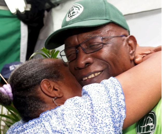 Jack Warner hugs a supporter