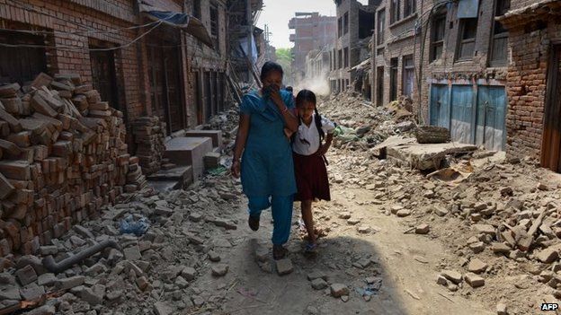 Schoolgirl Ankita Kapali, 11, walks with her mother past damaged buildings to school in Bhaktapur, near Kathmandu. Photo: 31 May 2015