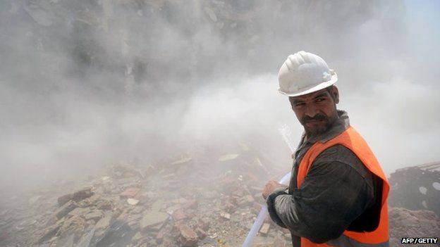 An Egyptian worker turns his face during the demolition of the headquarters of the once-dominant party of ex-president Hosni Mubarak on 31 May 2015 in Cairo