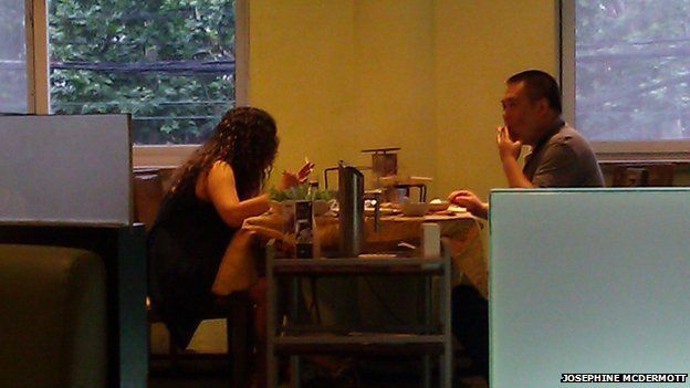 Couple smoking while eating at a hotpot restaurant in Shanghai