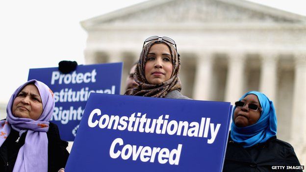 Muslim women rally outside the courthouse for the right to wear a headscarf at work