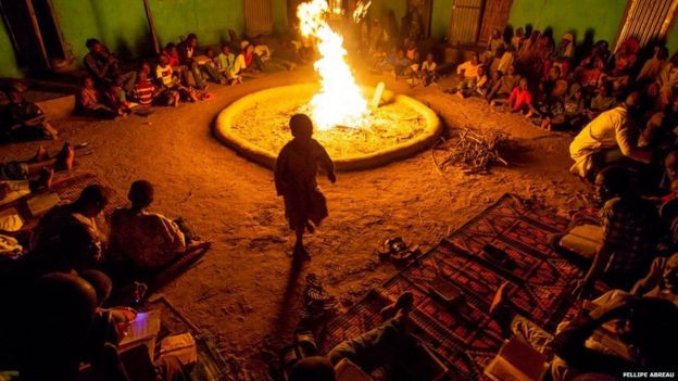 Boy dances around fire