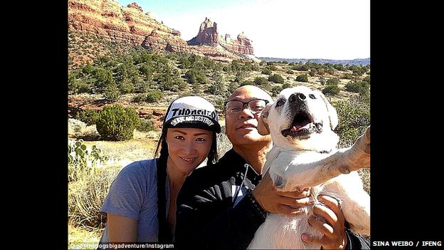 Chinese couple pose with their dog