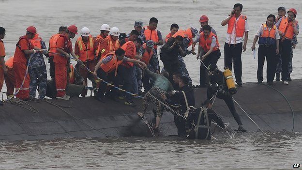 Rescuers save a survivor from the overturned passenger ship in the Jianli section of the Yangtze River in central China's Hubei Province on 2 June 2015