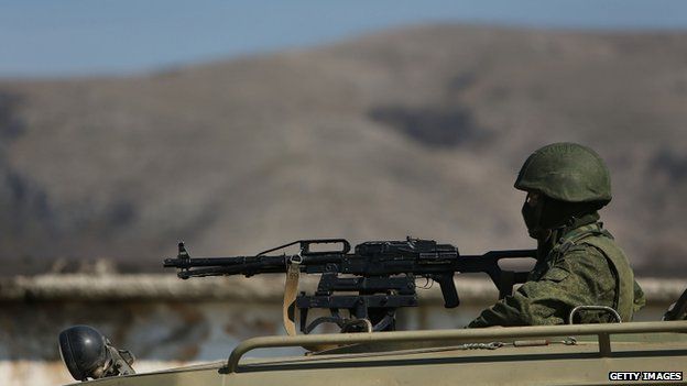 A Russian paramilitary soldier is viewed outside of a Ukrainian military base in the town of Perevevalne near the Crimean city of Simferopol on March 11, 2014 in Perevevalne, Ukraine