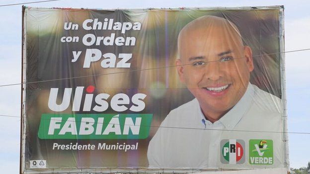 A photo shows a campaign poster of Ulises Fabian