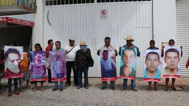 Relatives carry photographs of people who went missing in Chilapa in May