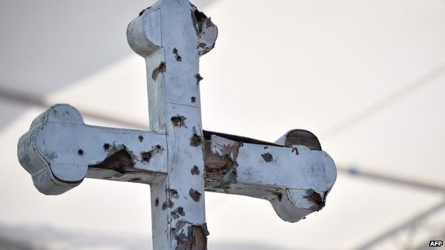 A bullet-scared cross on display at the Sarajevo stadium where the Pope celebrated Mass, 6 June 2015