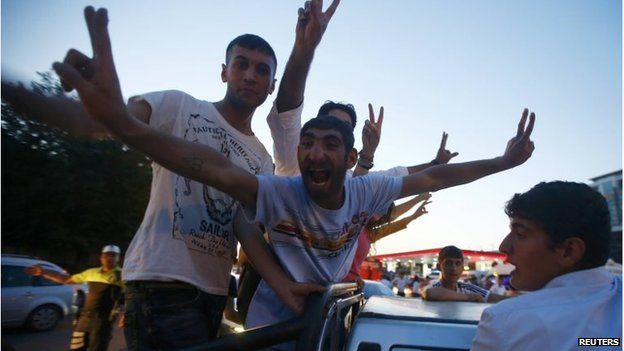 Supporters of the pro-Kurdish Peoples" Democratic Party (HDP) celebrate along a street after the parliamentary election in Diyarbakir