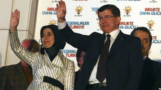 Turkey's Prime Minister and leader of ruling Justice and Development Party Ahmet Davutoglu and his wife Sare Davutoglu wave to supporterson 7 June
