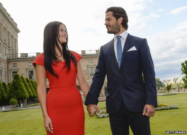 Swedish Prince Carl Philip poses with former model Sofia Hellqvist in the garden of the Stockholm Palace, on 27 June 2014 during a press statement to announce their engagement.