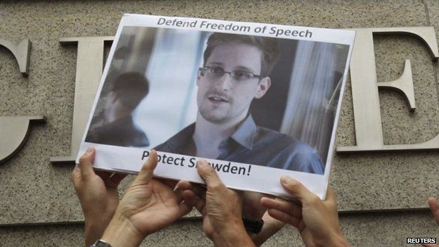 Protesters supporting Snowden hold a photo of him during a demonstration outside the U.S. Consulate in Hong Kong