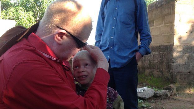 A fcommunity leader with a child in Ukerewe island, Tanzania (December 2014)
