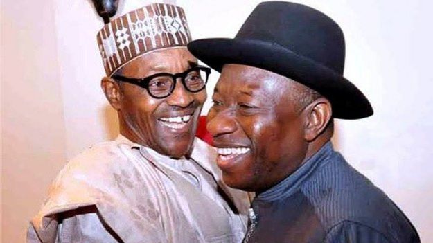 Nigerian President Goodluck Jonathan (R) and presidential candidate of the ruling People's Democratic Party (PDP) embraces leading opposition All Progressive Congress presidential candidate Mohammadu Buhari during a conference to promote non-violence attended by party leaders in Abuja, on 15 January 2015