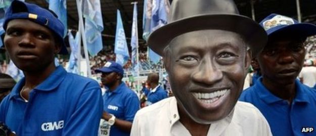 A supporter wearing a mask representing Nigeria's President Goodluck Jonathan in Port Harcourt in the Niger Delta region on 28 January 2015