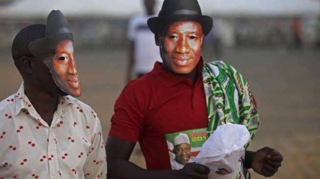 Supporters of Nigerian President Goodluck Jonathan, wear masks depicting his face during his visit in Yola, Nigeria, on 29 January 2015