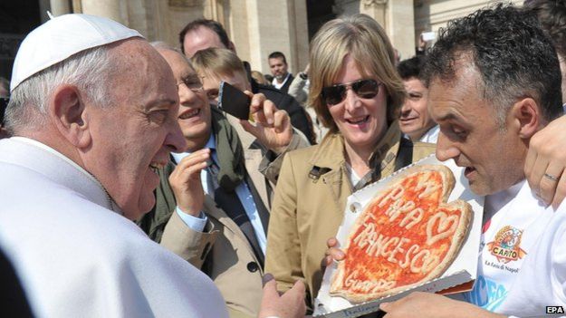 Pope Francis receiving a gift of a special pizza during his weekly general audience in Saint Peter's Square, Vatican City, 11 March 2015
