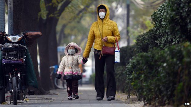 China woman and child, walking with face masks