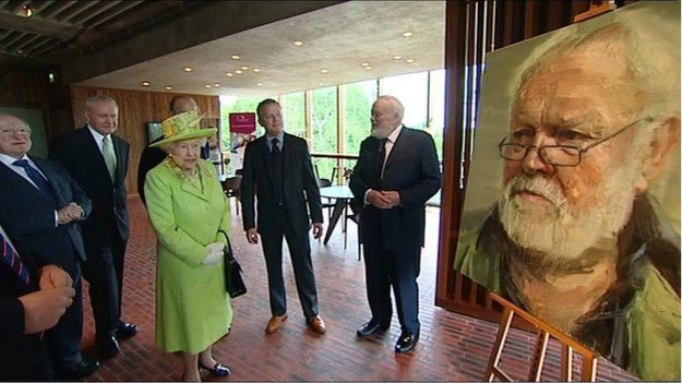 The Queen and Irish President Michael D Higgins speaking to the poet at Belfast's Lyric theatre in 2012
