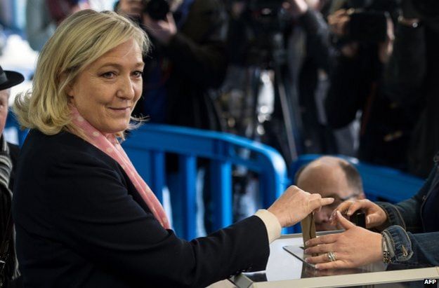 Marine Le Pen smiles as she casts her ballot during the first round of the French departmental elections on 22 March 2015 in Henin-Beaumont
