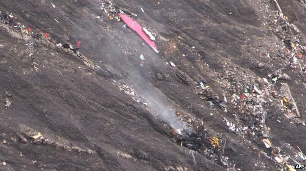 Smoke billowing from scattered debris of the Germanwings Airbus A320 at the crash site