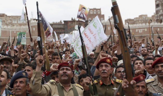 Houthi rebels hold up their weapons to protest against Saudi-led airstrikes, during a rally in Sanaa, Yemen, 26 March 2015
