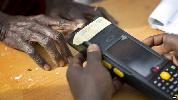 Nigerian woman validating her voting card by using a fingerprint reader; 28 March 2015