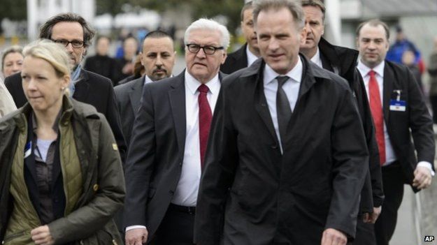 German Foreign Minister Frank-Walter Steinmeier, center, walks outside the hotel during negotiations on Iran's nuclear program between Iran and world powers in Lausanne, Switzerland, 29 March 2015