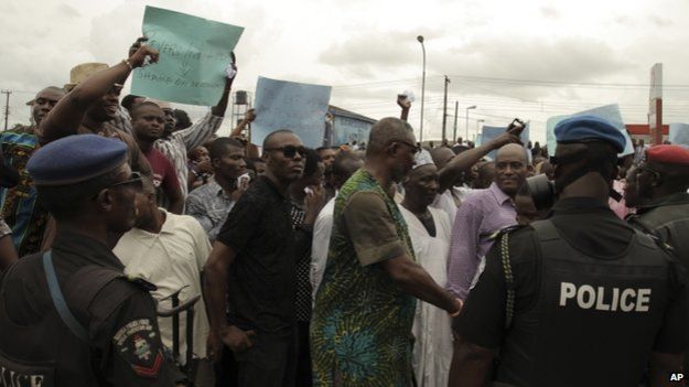 Security forces stand in front of protesters against the recent election in Port Harcourt , Nigeria, Sunday, March 29, 2015