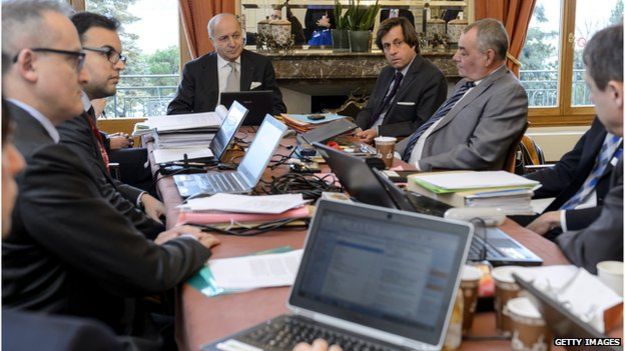 French Foreign Minister Laurent Fabius (C) and director-general for political and security affairs at the French Foreign Ministry Nicolas de Riviere (C-R) attend a working session with their team on 29 March