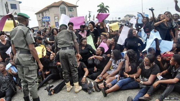 All Progressives Congress (APC) party supporters sit on the floor during a march towards the Independent National Electoral Commission Office in Port Harcourt calling for the cancellation of the presidential elections in the Rivers State on 30 March 2015