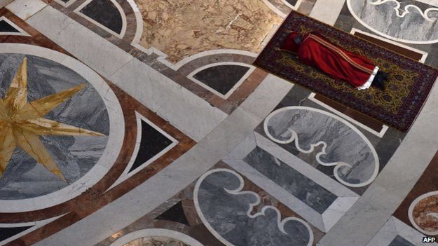 Pope Francis prays face down, on the floor of St. Peter's Basilica during the Celebration of Lord's Passion on Good Friday on April 3, 2015 in Vatican