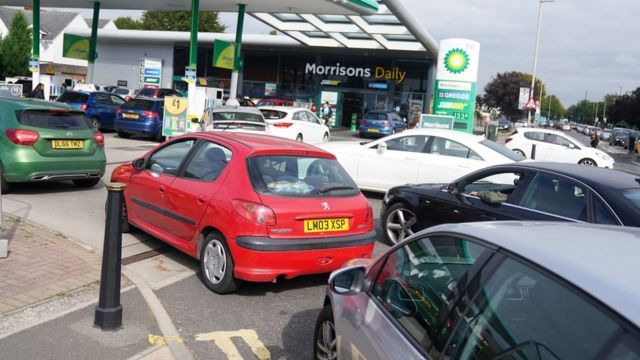 Drivers queuing at a petrol station