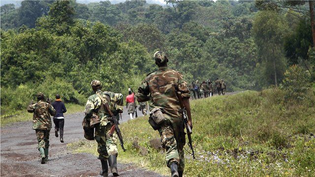 A column of Congolese M23 rebels is seen running on the Goma to Rushuru road