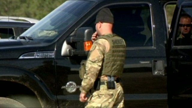 Sheriff in camouflage clothing at the site of the hostage