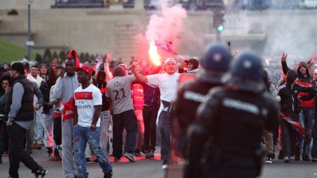 PSG supporters squaring up to riot police