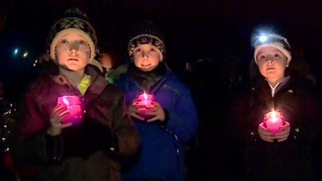 Children holding candles