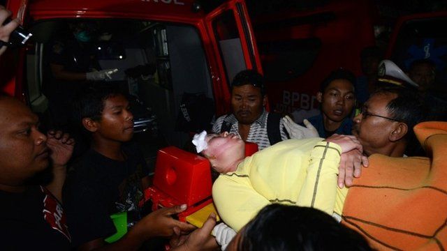A Japanese scuba diver is carried to an ambulance