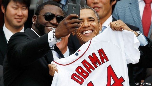 Boston Red Sox player David Ortiz (left) poses for a "selfie" with President Barack Obama