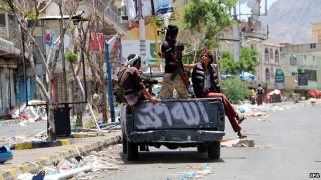 Tribal fighters loyal to Yemen's exiled government patrol at a street following heavy clashes with Houthi rebels and their allies in the central city of Taiz, Yemen,