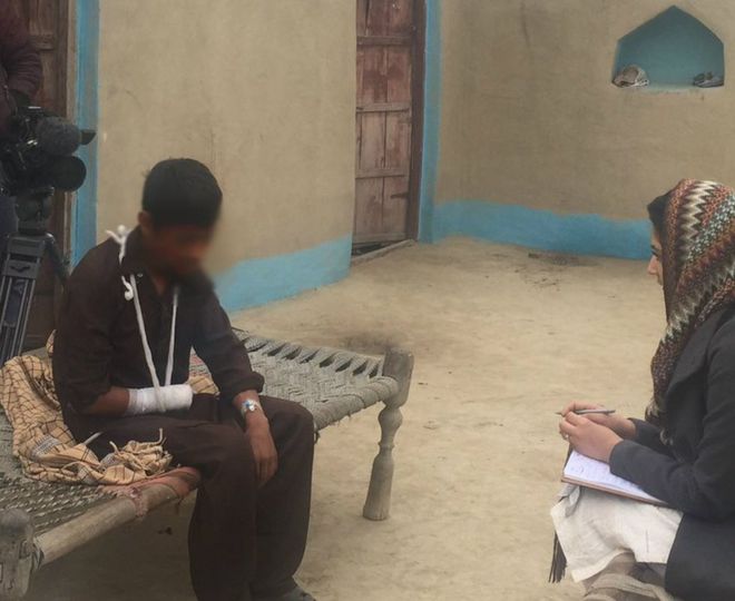 Qaiser during an interview with the BBC's reporter, showing his bandaged arm