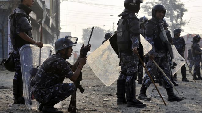 Nepalese riot police advance on activists during clashes near the Nepal-India border at Birgunj, some 90 km south of Kathmandu, on November 4, 2015