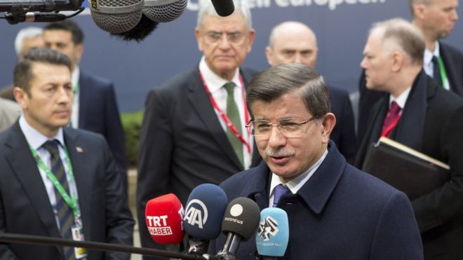 Turkish Prime Minister Ahmet Davutoglu addresses media as he arrives for EU summit in Brussels. 18 March 2016.