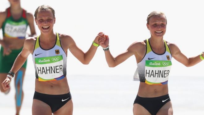 Anna Hahner (L) of Germany and her sister Lisa Hahner approach the finish line during the Women's Marathon on Day 9 of the Rio 2016 Olympic Games at the Sambodromo on 14 August 2016 in Rio de Janeiro, Brazil