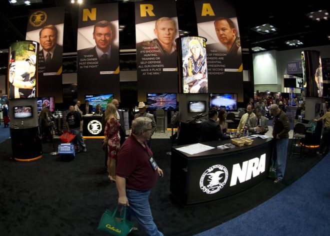 onvention goers walk through the NRA booth at the143rd NRA Annual Meetings and Exhibits at the Indiana Convention Center in Indianapolis, Indiana on April 25, 2014