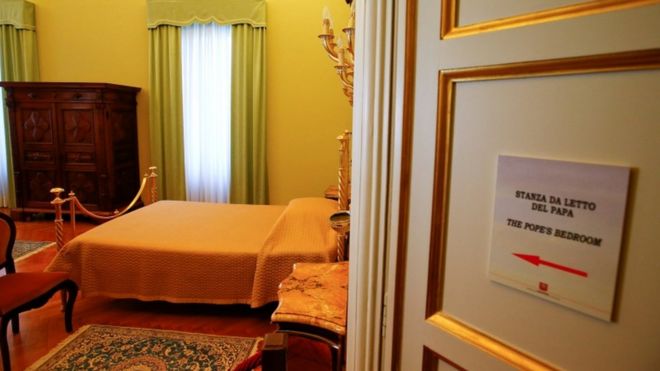 Bedroom door opens showing the Pope's bed