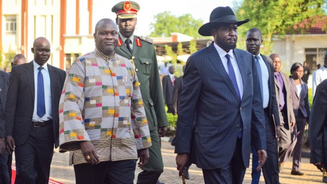 Riek Machar walks alongside President Salva Kiir on the red carpet