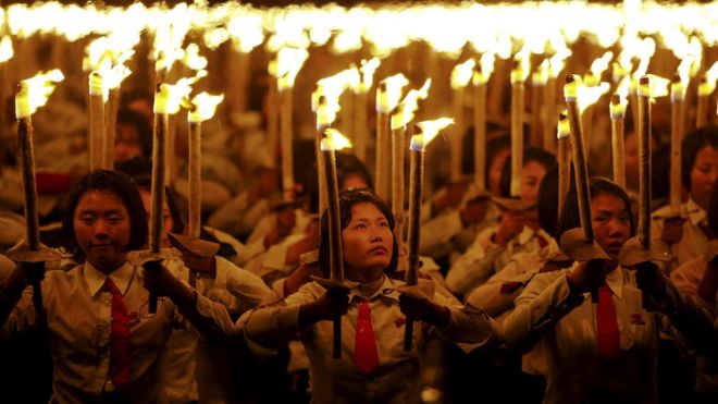 People holding torches during a performance held after the military parade for the 70th anniversary of the founding Workers' Party, Pyongyang, North Korea - Saturday 10 October 2015